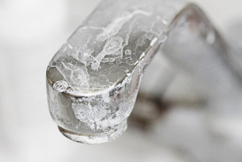 A faucet showing the effects of hard water buildup